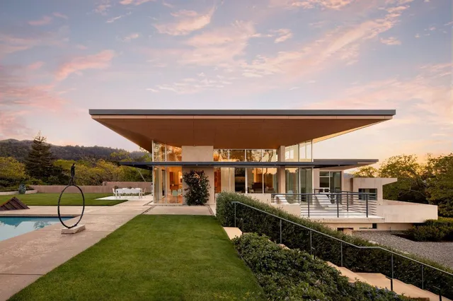 a view of a swimming pool with a patio and a yard