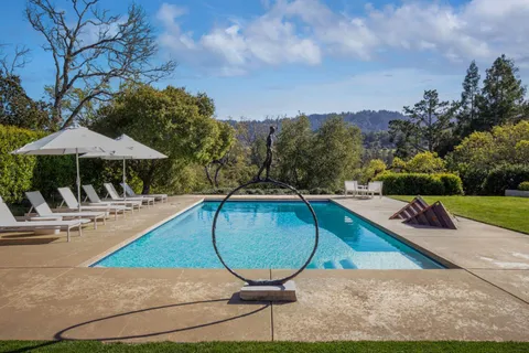 a view of swimming pool with sitting area and furniture