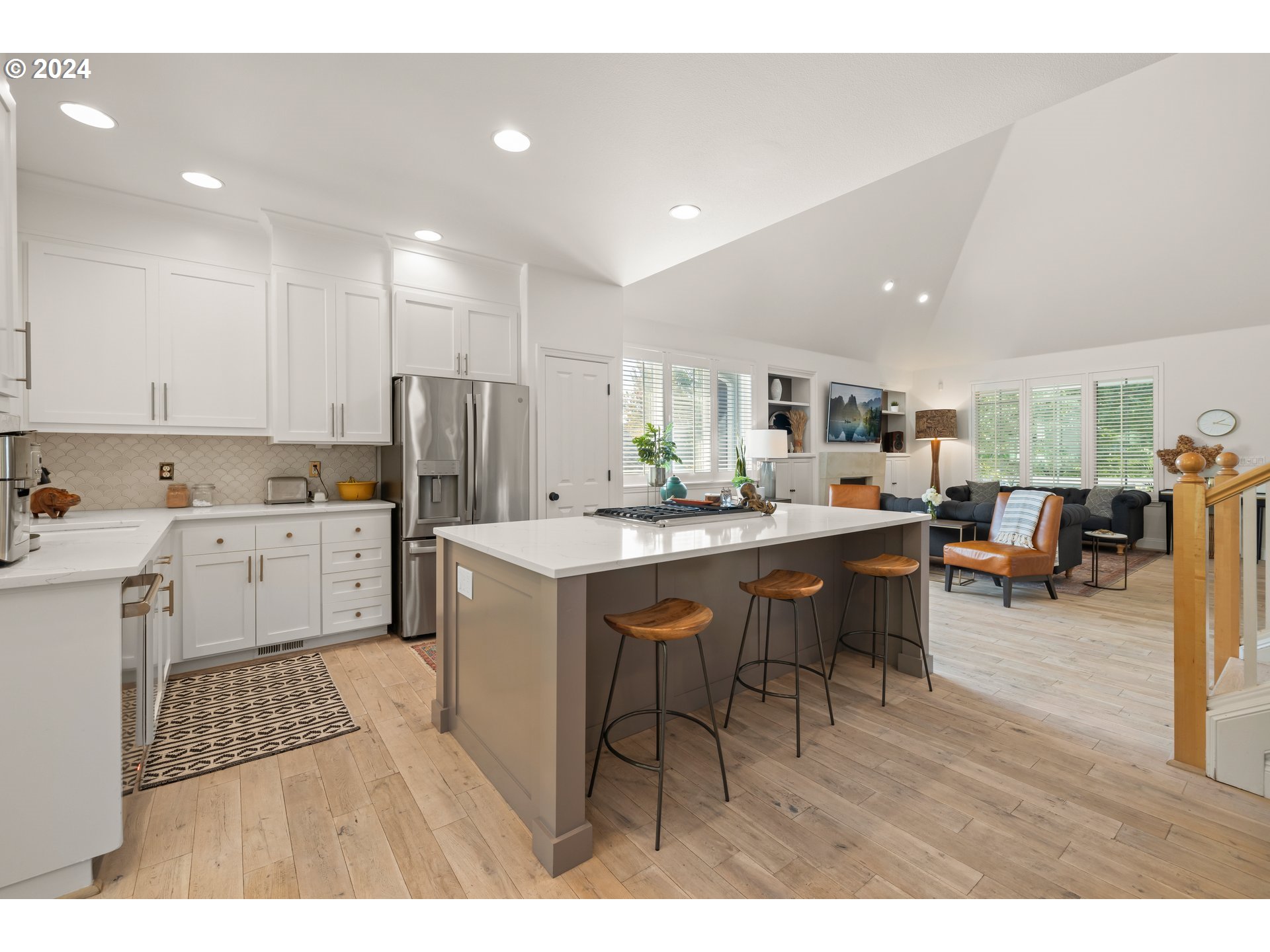 2534 Northwest Rhodes Lane Portland, OR 97229 - Photo 11 of 41 a kitchen with a table chairs refrigerator and cabinets
