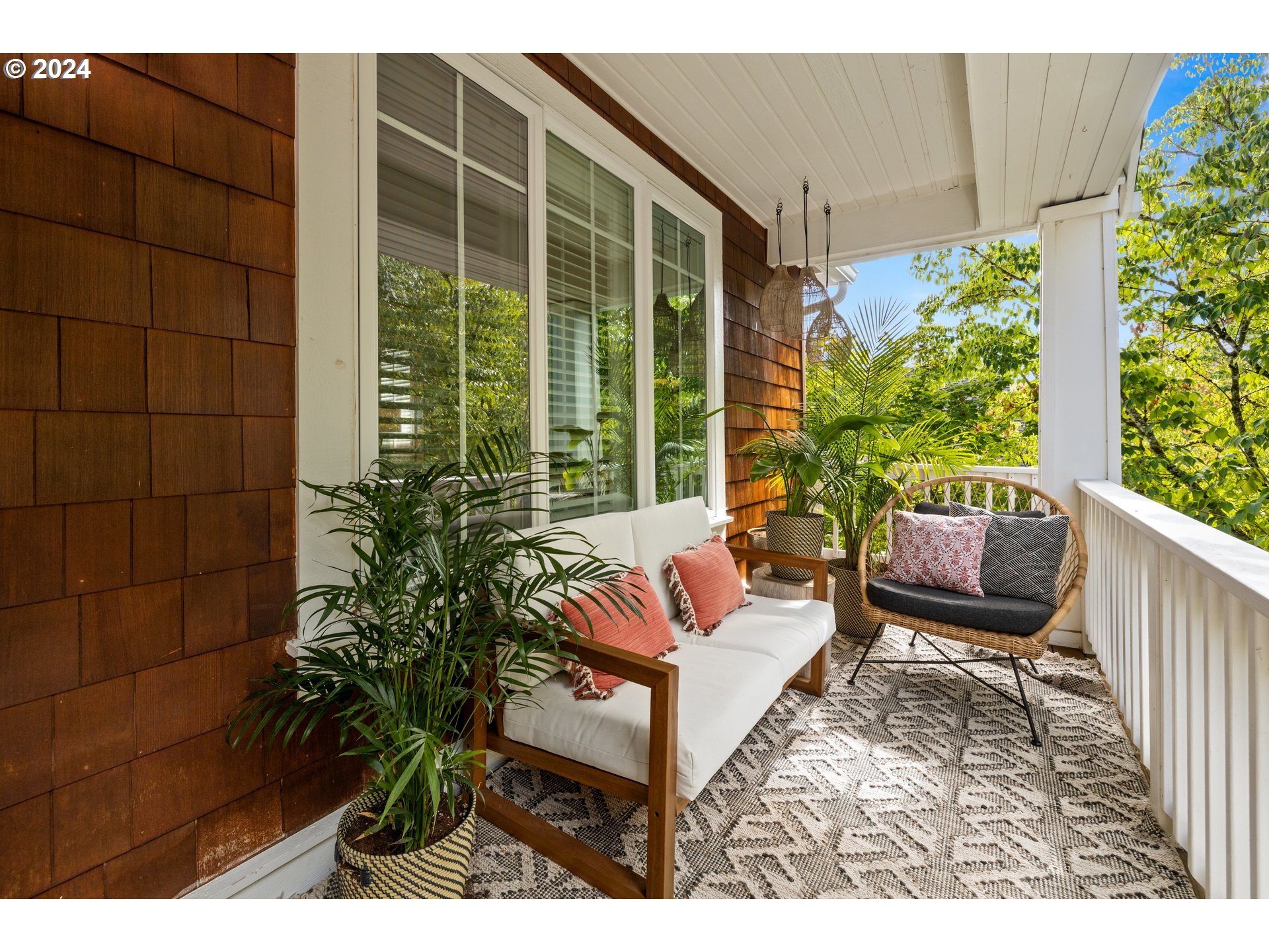 2534 Northwest Rhodes Lane Portland, OR 97229 - Photo 2 of 41 a balcony with couch and flowers