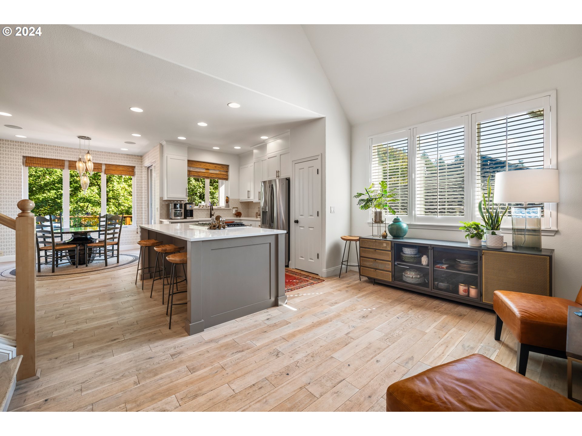 2534 Northwest Rhodes Lane Portland, OR 97229 - Photo 8 of 41 a living room with stainless steel appliances kitchen island granite countertop furniture and a wooden floor