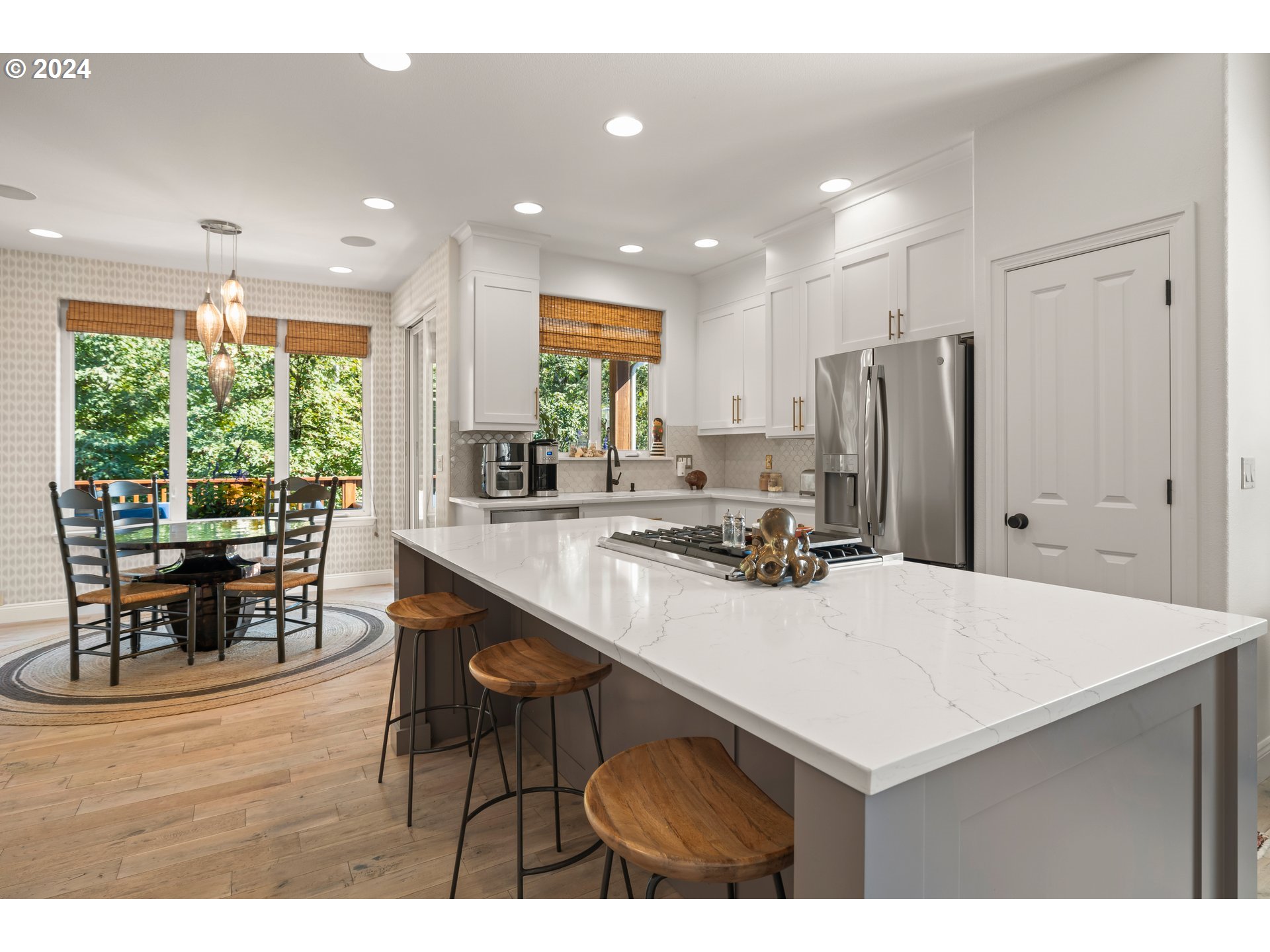 2534 Northwest Rhodes Lane Portland, OR 97229 - Photo 9 of 41 a kitchen with kitchen island a stove a table and chairs