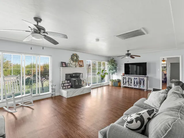 a living room with fireplace furniture and a wooden floor