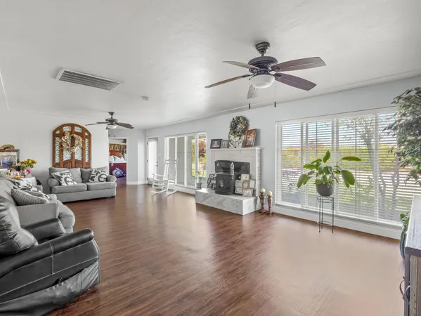 a living room with furniture and wooden floor