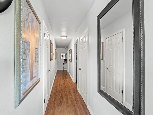 a bed room with a bed and a mirror on a dresser