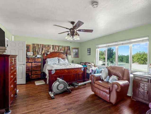 a bedroom with furniture and a large window