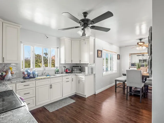 a kitchen with sink a microwave and cabinets