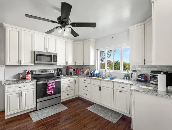 a view of a dining room with furniture a chandelier and wooden floor