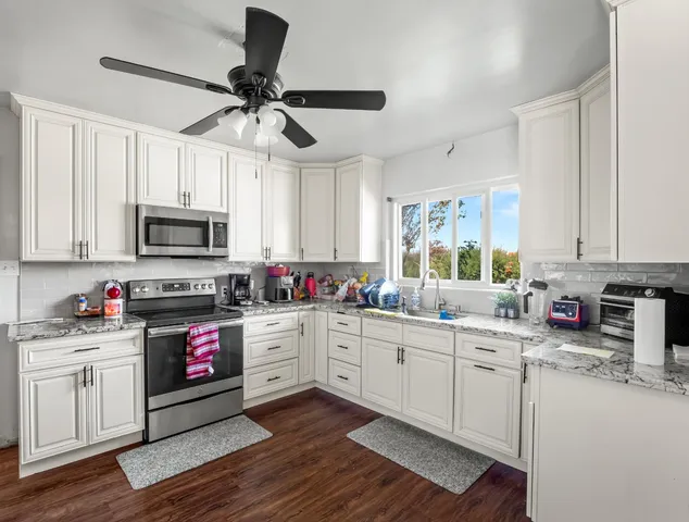 a view of a dining room with furniture a chandelier and wooden floor