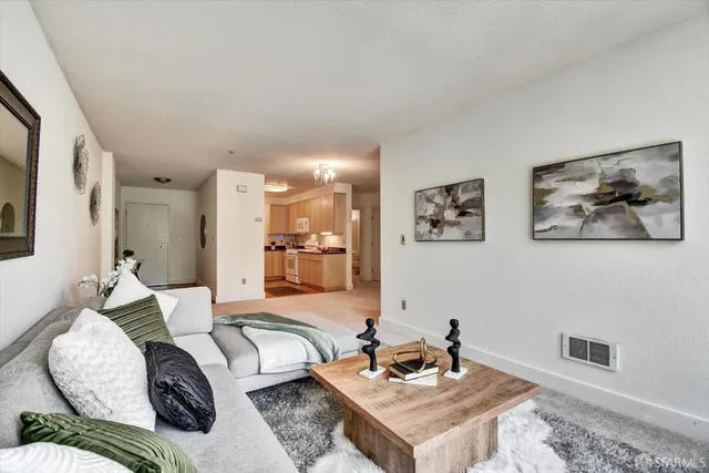 a living room with furniture and a kitchen