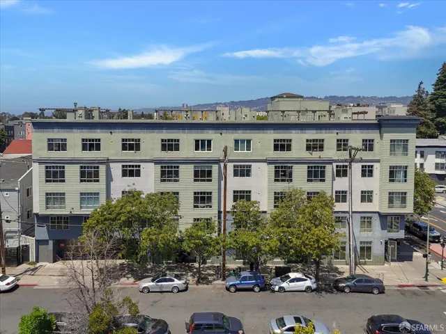 a view of a tall building next to a road