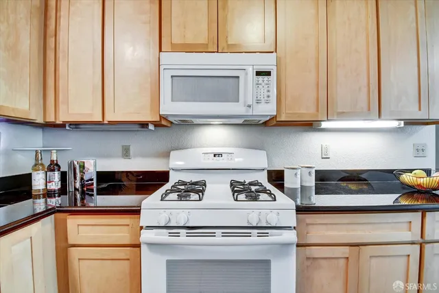 a kitchen with stainless steel appliances a refrigerator and a stove
