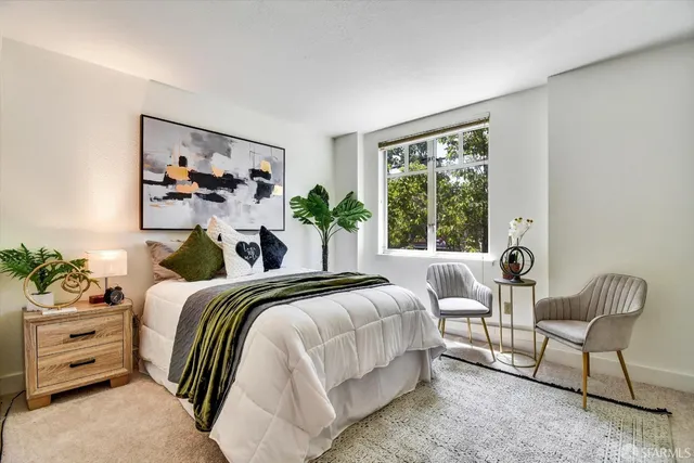 a bedroom with a bed and a chair