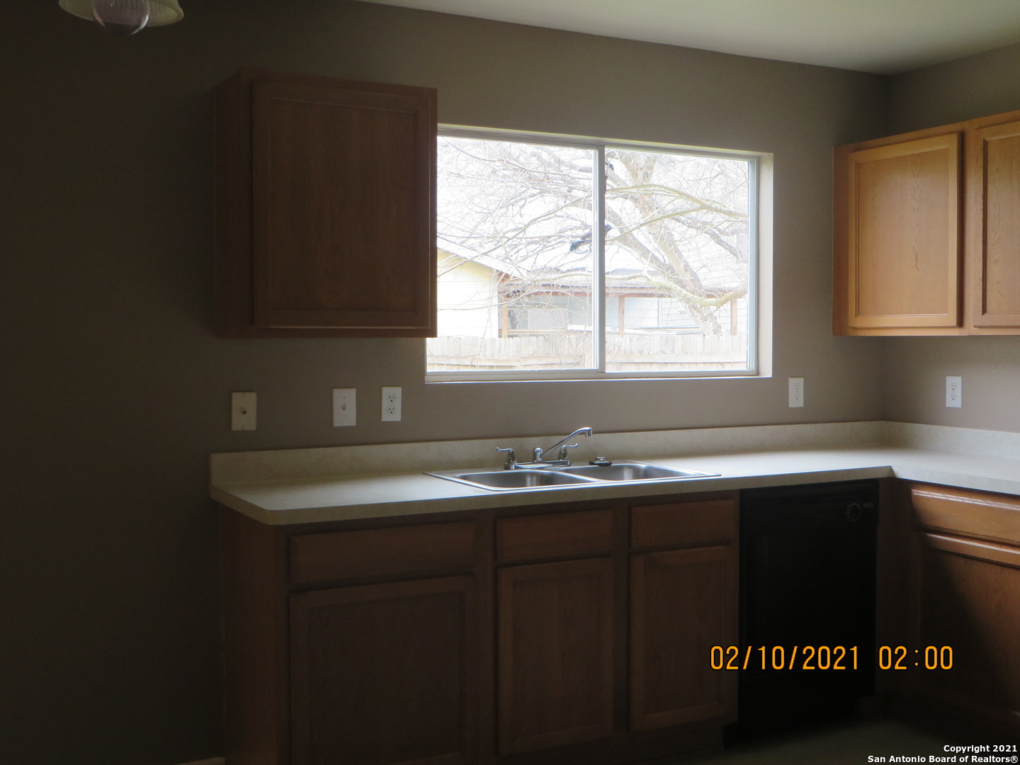 4630 Rothberger Way San Antonio, TX 78244 - Photo 3 of 13 a kitchen with a sink a window and cabinets