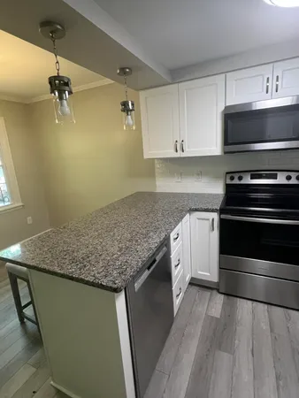 a kitchen with a stove and a white cabinets