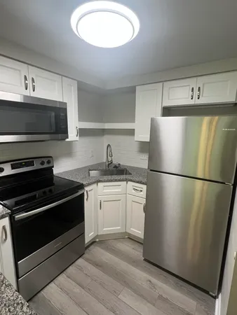 a kitchen with a refrigerator stove and microwave