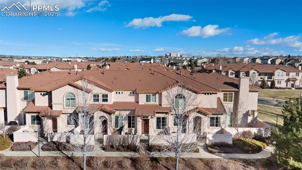7022 Sand Crest View Colorado Springs, CO 80923 - Photo 2 of 13 a view of a city with lots of residential buildings ocean and mountain view in back