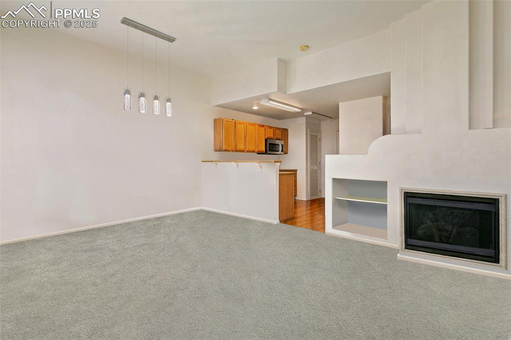 7022 Sand Crest View Colorado Springs, CO 80923 - Photo 6 of 13 a view of empty room with fireplace and window