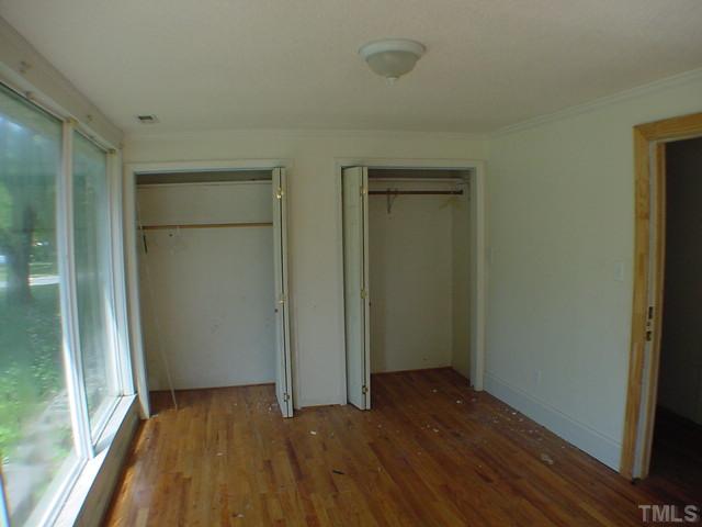 7725 Rock Quarry Road Raleigh, NC 27610 - Photo 5 of 7 an empty room with wooden floor and a window