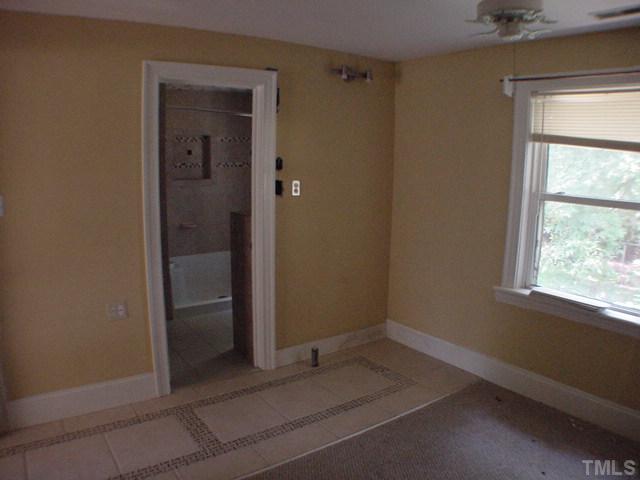7725 Rock Quarry Road Raleigh, NC 27610 - Photo 6 of 7 an empty room with windows and closet
