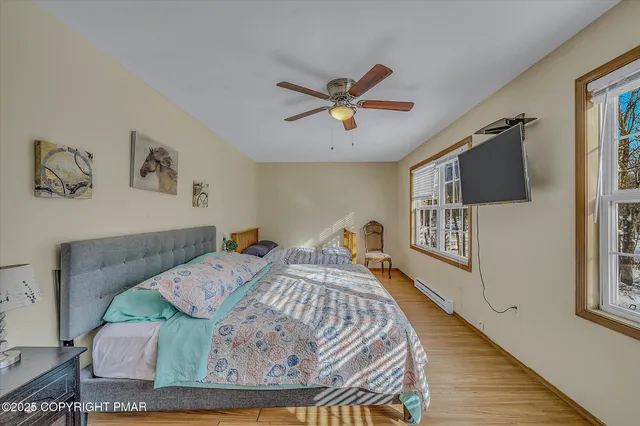 a bedroom with two beds and a window
