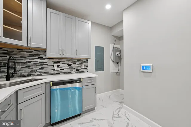 a kitchen with cabinets appliances and a counter top