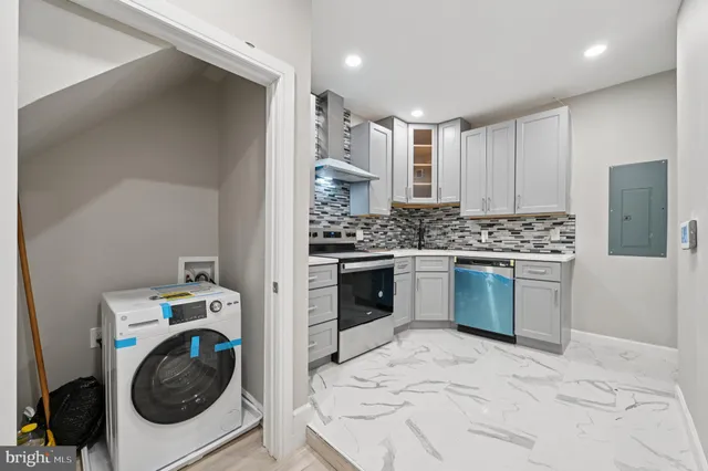 a kitchen with a stove a sink and a refrigerator