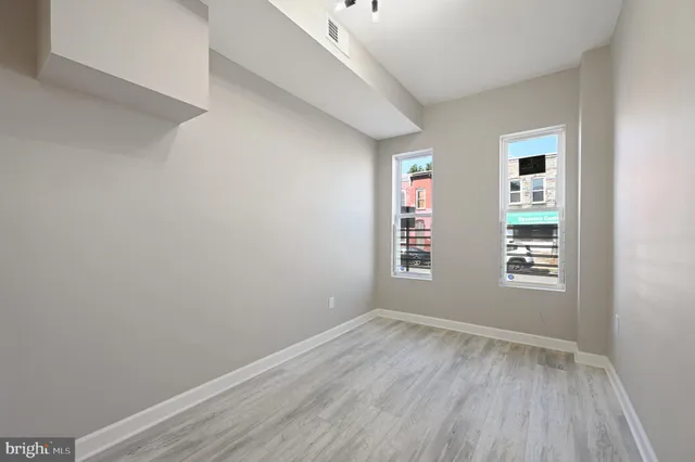 a view of room with window and hardwood floor