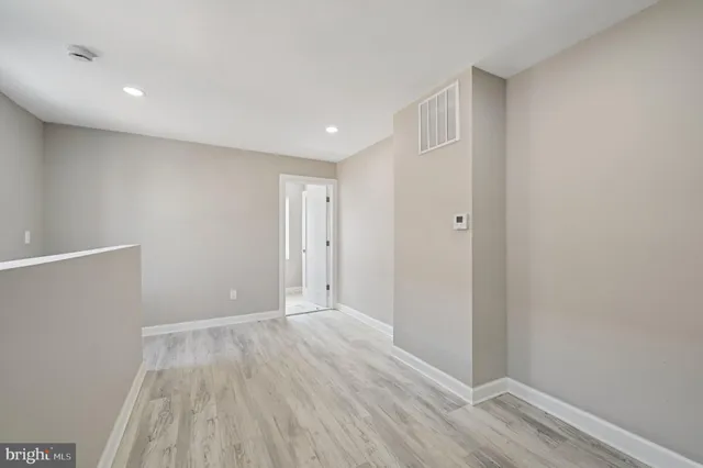 a view of hallway with wooden floor
