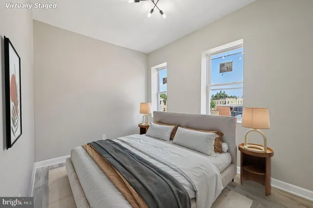 a bedroom with a bed and a night stand