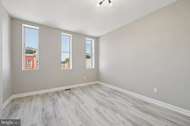 a view of room with window and hardwood floor
