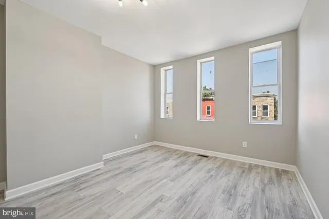 a view of room with window and hardwood floor