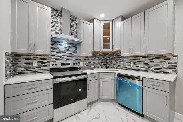 a kitchen with granite countertop white cabinets and white appliances