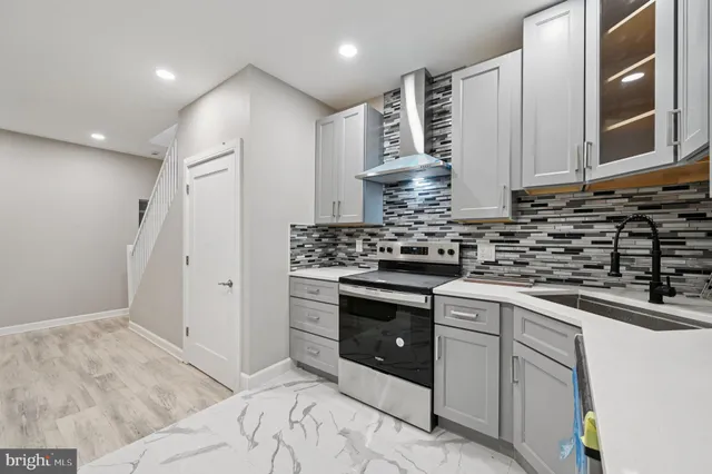 a kitchen with stainless steel appliances granite countertop a sink and cabinets