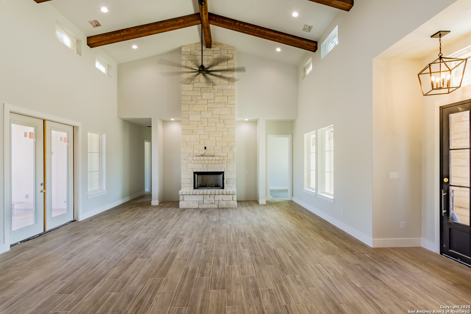 246 Timber Place La Vernia, TX 78121 - Photo 11 of 33 a view of empty room with wooden floor and fan