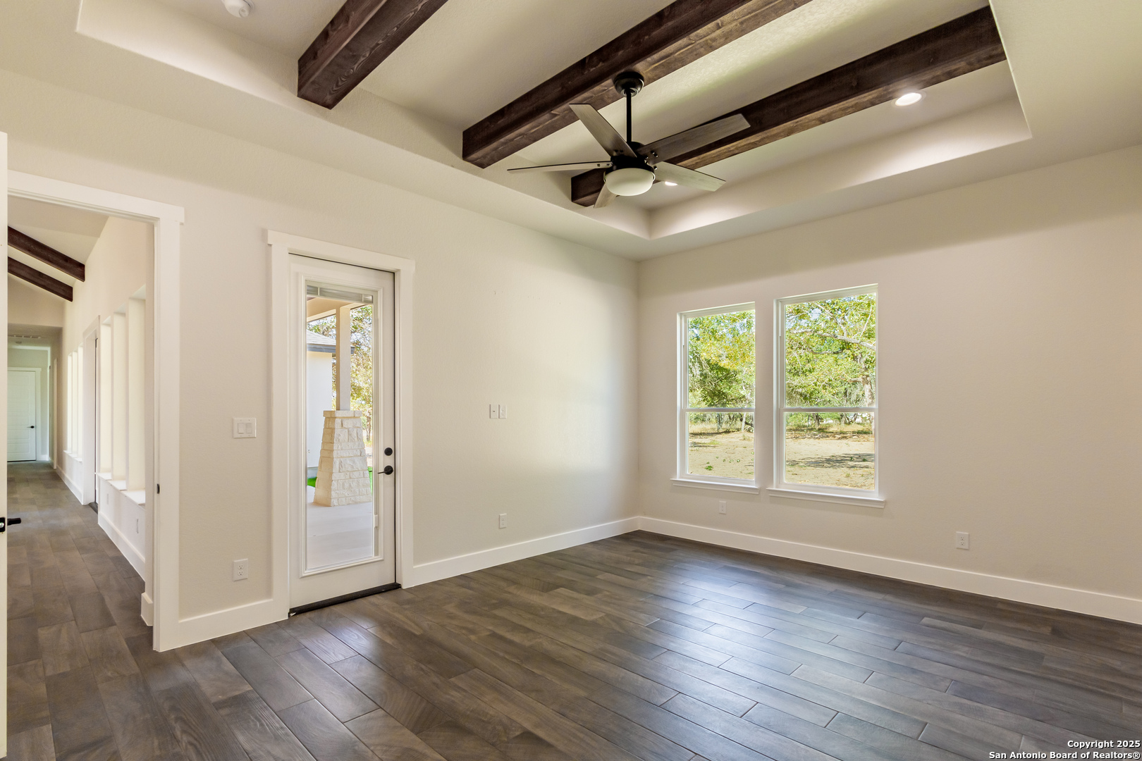 246 Timber Place La Vernia, TX 78121 - Photo 13 of 33 a view of an empty room with wooden floor and a window