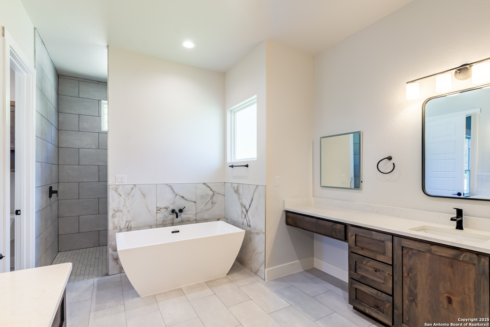 246 Timber Place La Vernia, TX 78121 - Photo 16 of 33 a bathroom with a large tub sink and mirror