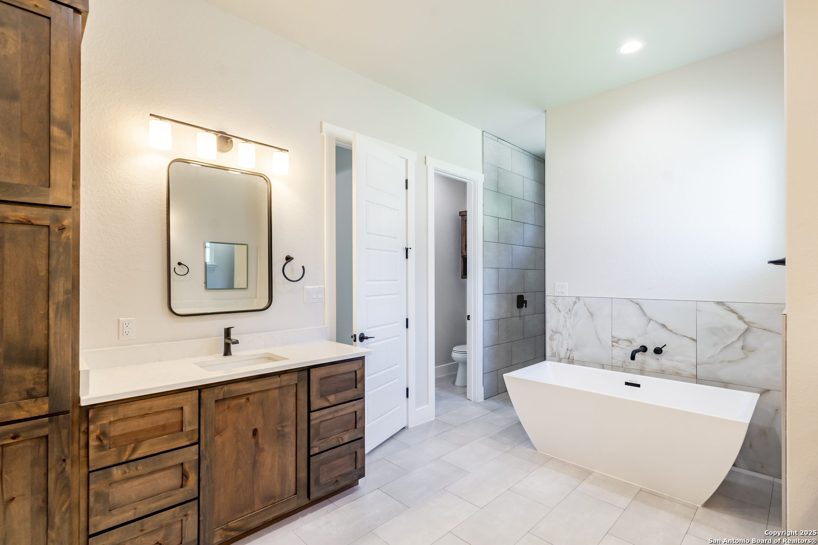246 Timber Place La Vernia, TX 78121 - Photo 17 of 33 a spacious bathroom with a double vanity sink mirror and bathtub