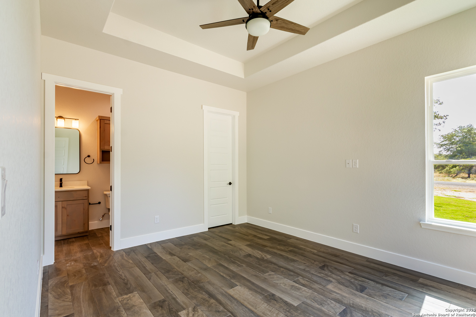 246 Timber Place La Vernia, TX 78121 - Photo 23 of 33 wooden floor in an empty room with a window