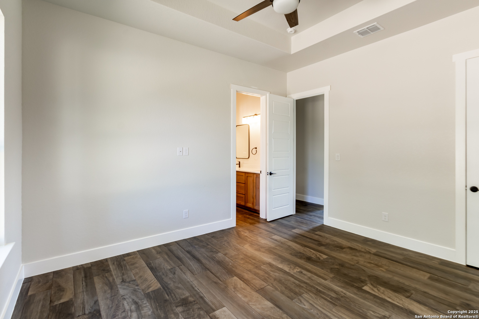 246 Timber Place La Vernia, TX 78121 - Photo 24 of 33 an empty room with wooden floor and windows