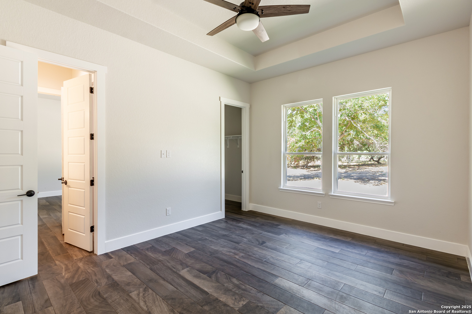 246 Timber Place La Vernia, TX 78121 - Photo 25 of 33 a view of an empty room with wooden floor and a window