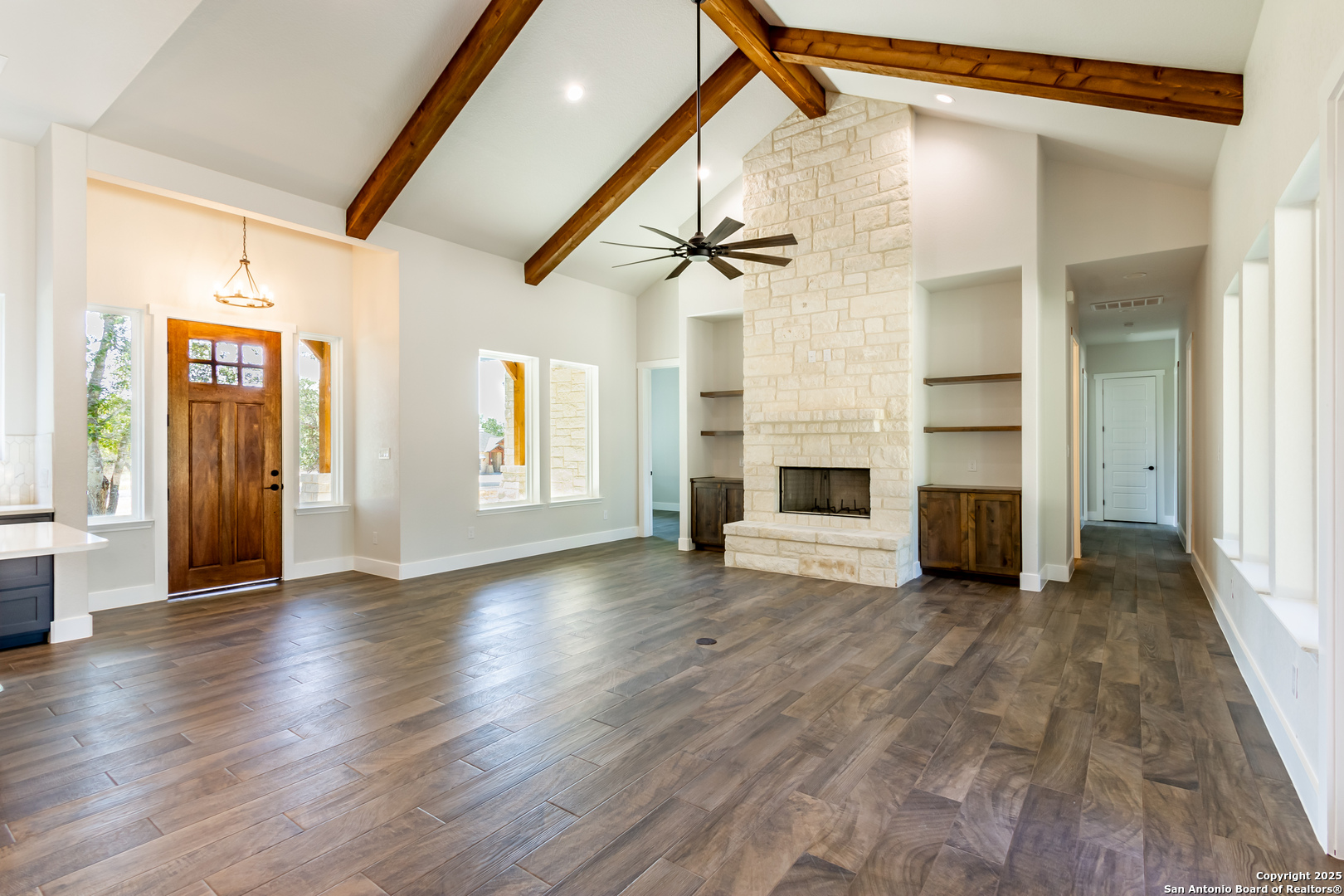 246 Timber Place La Vernia, TX 78121 - Photo 9 of 33 a view of a livingroom with wooden floor and a fireplace