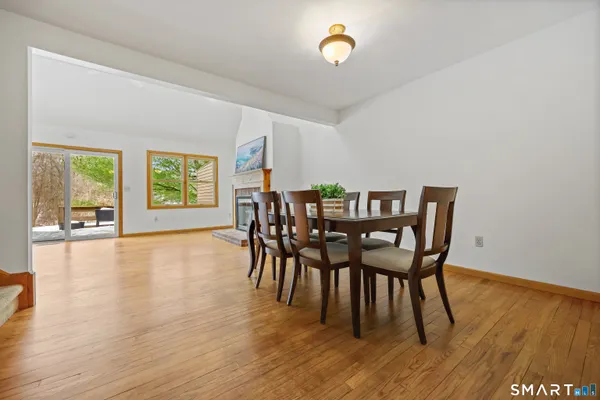 a view of a dining room with furniture and wooden floor