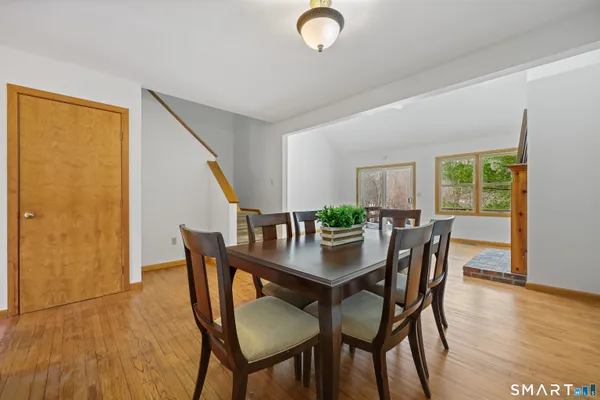 a view of a dining room with furniture and wooden floor