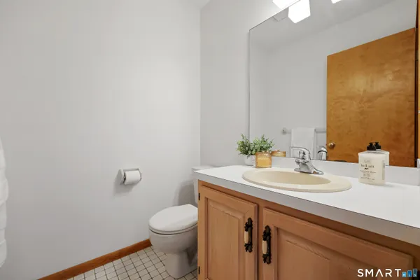 a bathroom with a sink a toilet and mirror