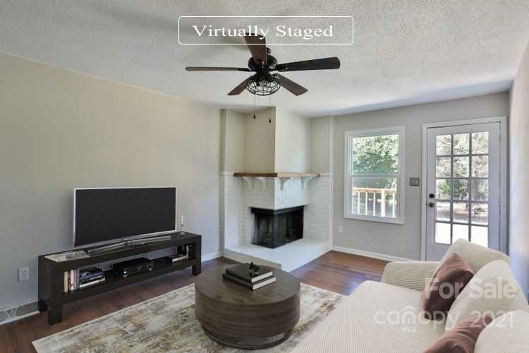 7825 Davis Road Mint Hill, NC 28227 - Photo 2 of 16 a living room with furniture a flat screen tv and a fireplace