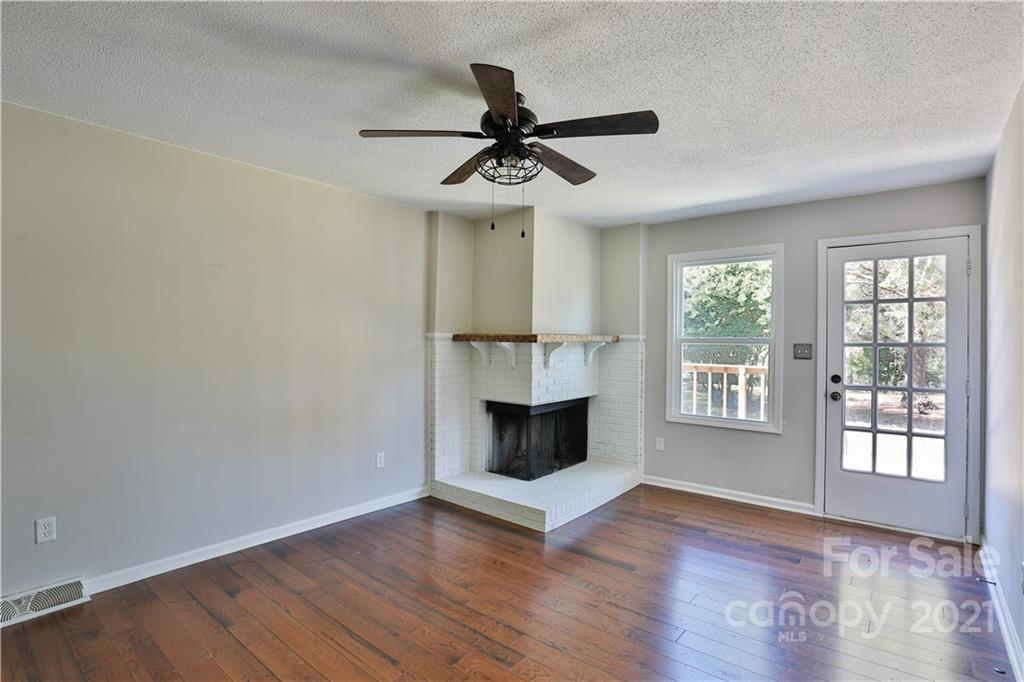 7825 Davis Road Mint Hill, NC 28227 - Photo 3 of 16 a view of an empty room with a fireplace and a window