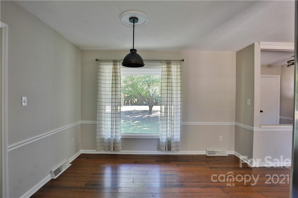 7825 Davis Road Mint Hill, NC 28227 - Photo 4 of 16 a view of empty room with wooden floor and fan