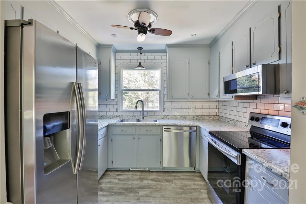7825 Davis Road Mint Hill, NC 28227 - Photo 5 of 16 a kitchen with stainless steel appliances granite countertop a sink stove and refrigerator