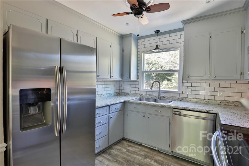 7825 Davis Road Mint Hill, NC 28227 - Photo 6 of 16 a kitchen with a sink stainless steel appliances a window and a refrigerator